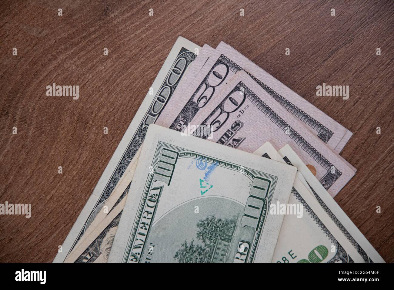 Closeup American cash banknotes of 50 dollars and 100 dollars bill marked by inked symbols. Green and blue ink strange symbols stamped on dollar bill. Stock Photo