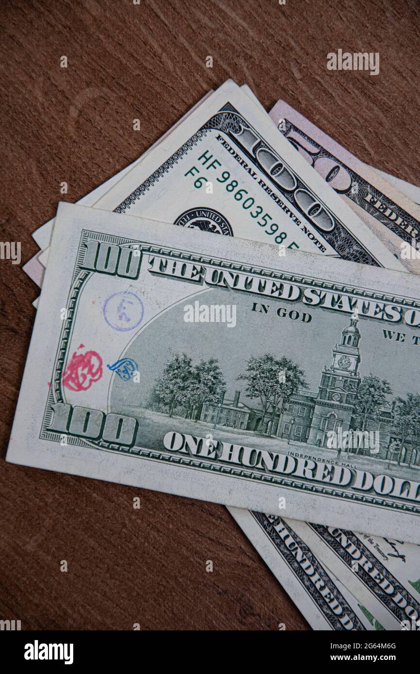 Closeup American cash banknotes of 50 dollars and 100 dollars bill marked by inked symbols. Red and blue ink strange symbols stamped on dollar bill. U Stock Photo