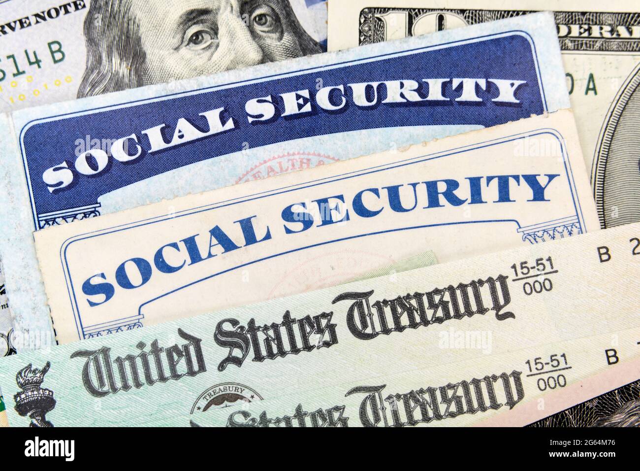 Macro view of Social Security cards, United States Treasury checks and cash. Stock Photo