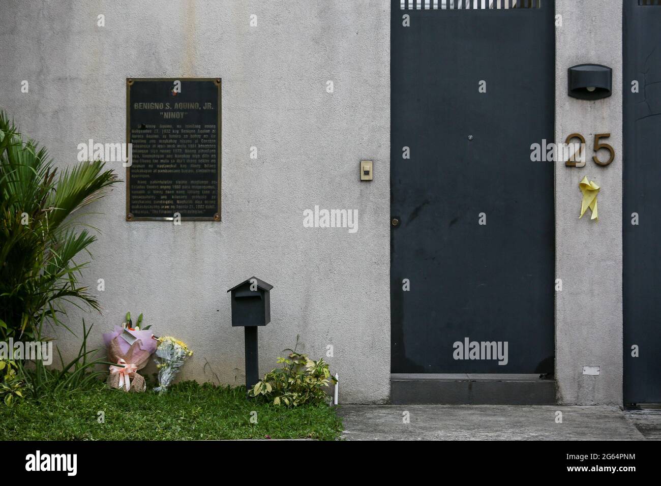 Flowers are placed outside the house of former Philippine President Benigno Aquino III who died at the age of 61 in Manila, Philippines. Stock Photo