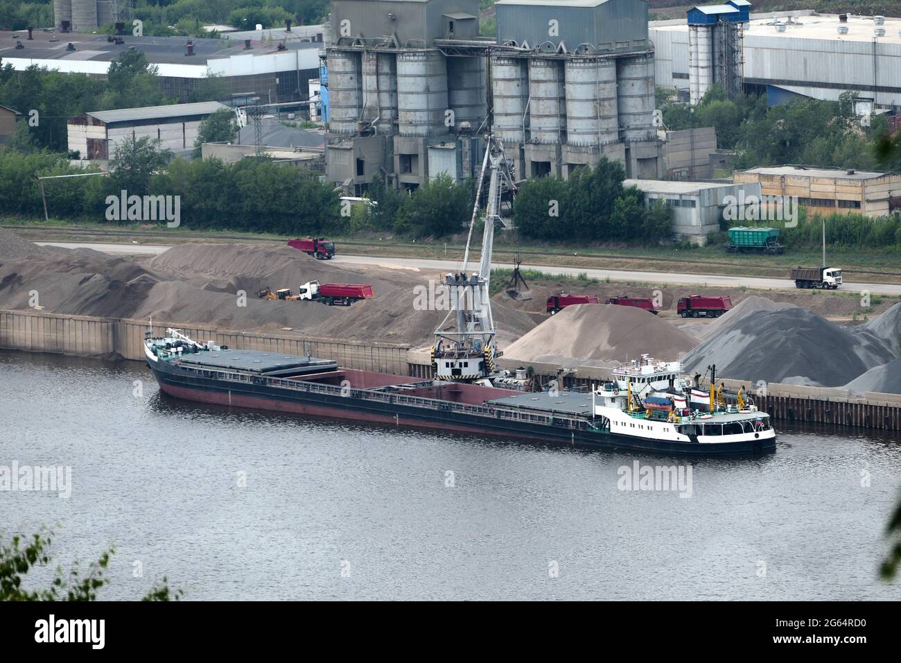 Barge on the river Unloading river sand from a barge Navigable river, river port Stock Photo