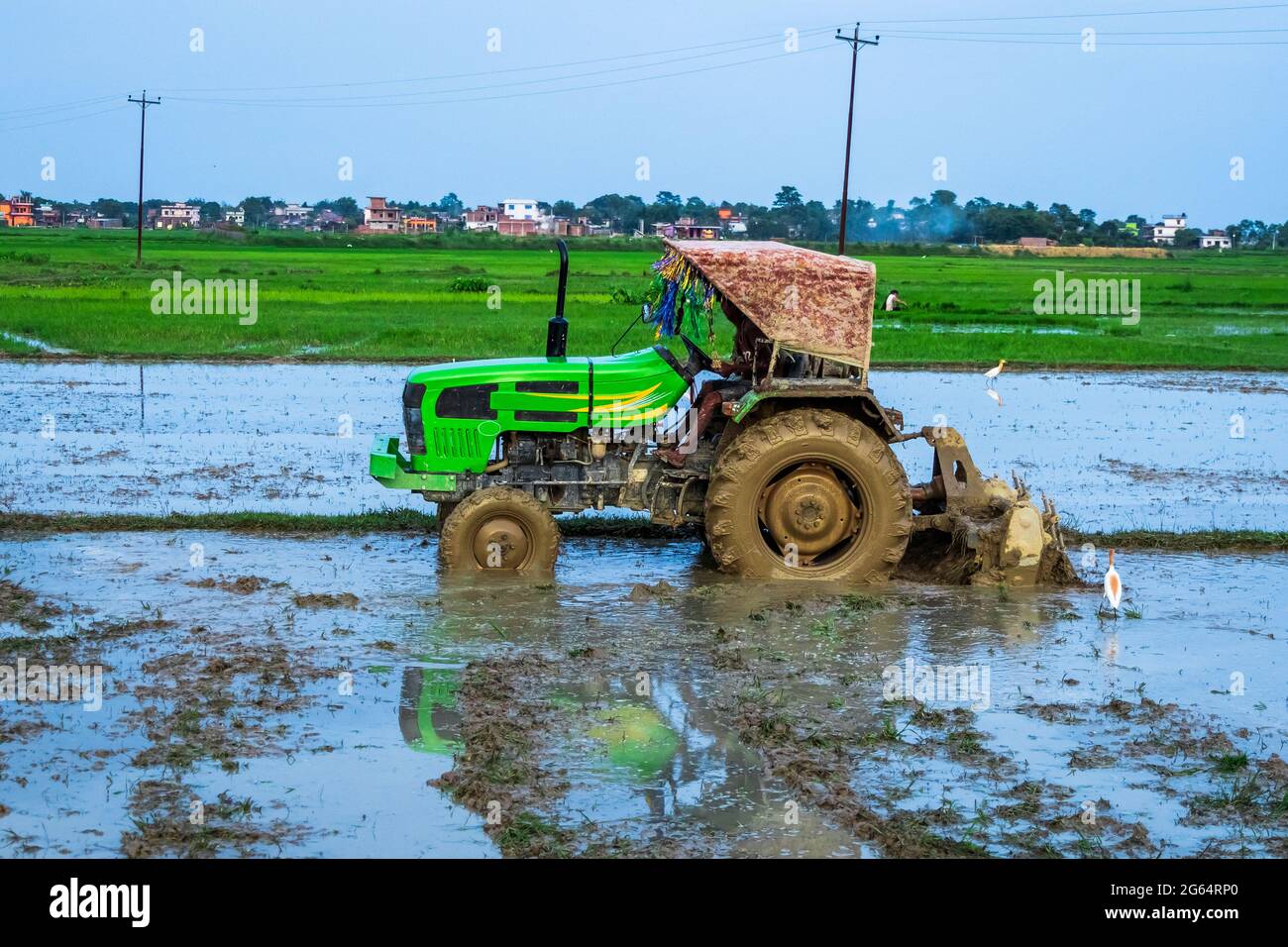 Tractor Ploughs Field. Heavy duty tractor ploughs through muddy field
