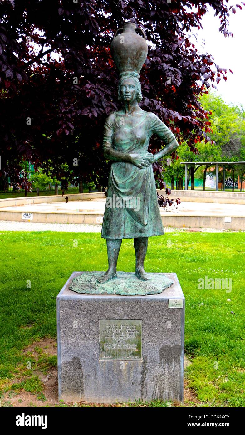 Bronze statue of a woman the water carrier with a vase balanced on her