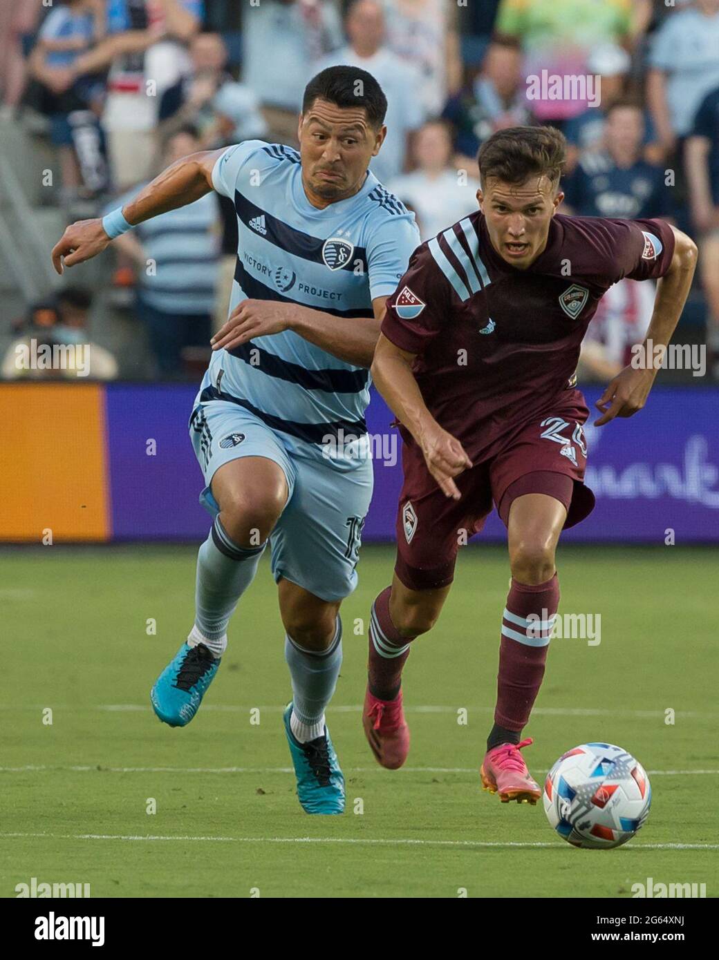 Kansas City, Kansas, USA. 23rd June, 2021. Colorado Rapids midfielder Cole Bassett #26 (r) and Sporting KC midfielder Roger Espinoza #15 (l) vie for field control at Sporting KC's defense during the first half of the game. Credit: Serena S.Y. Hsu/ZUMA Wire/Alamy Live News Stock Photo