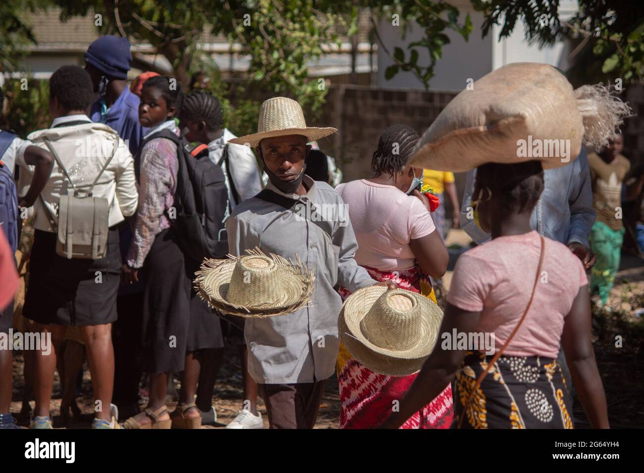 Artist selling straw hats on the street Stock Photo