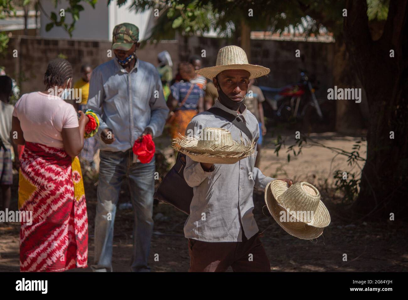 Artist selling straw hats on the street Stock Photo
