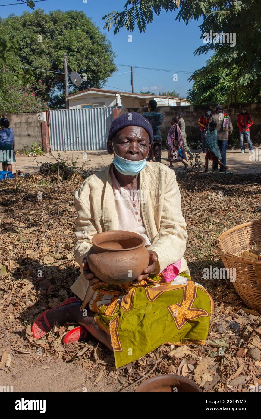 Woman selling handmade clay pots Stock Photo