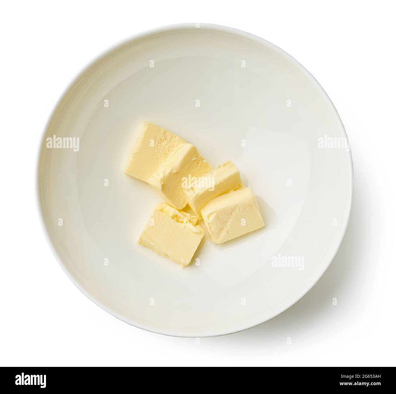 butter pieces for making custard cream in a bowl isolated on white background, top view Stock Photo