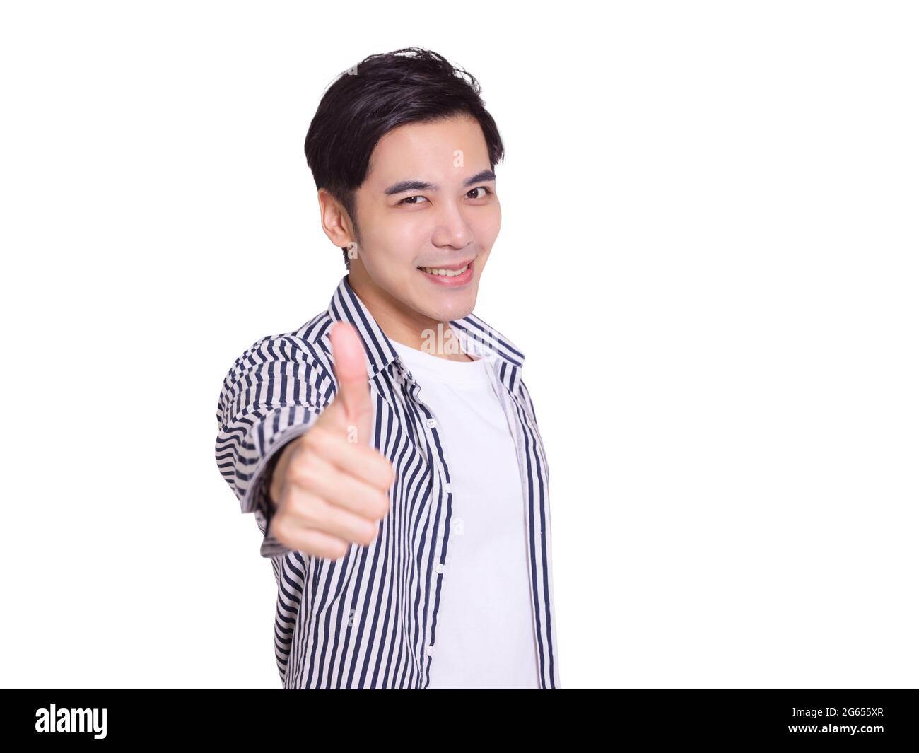 young man smiling and making thumbs up gesture Stock Photo