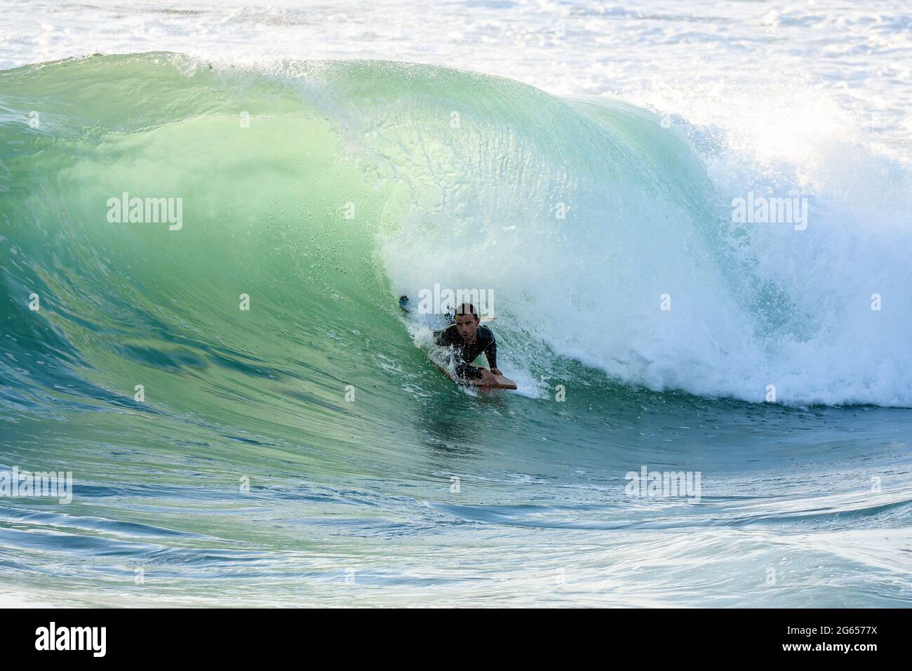 Bodyboarder surfing ocean wave on a sunny day Stock Photo - Alamy