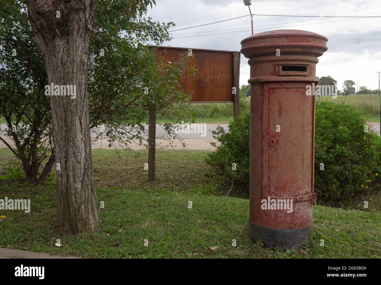 Old mailbox next to a tree. Stock Photo
