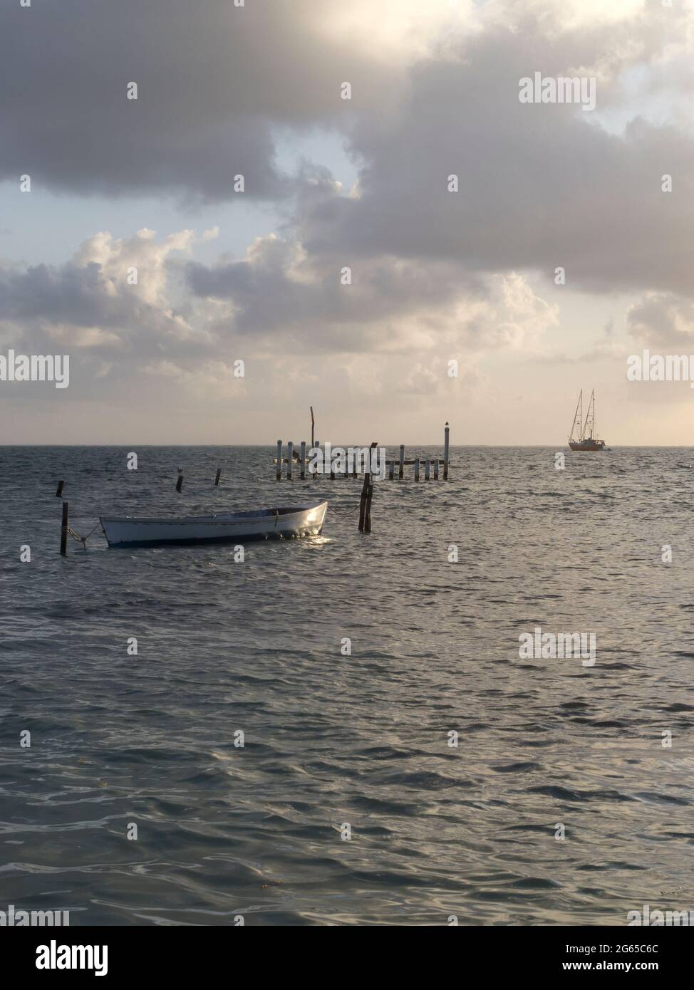 The early morning sunlight reflects off of a small boat Stock Photo - Alamy