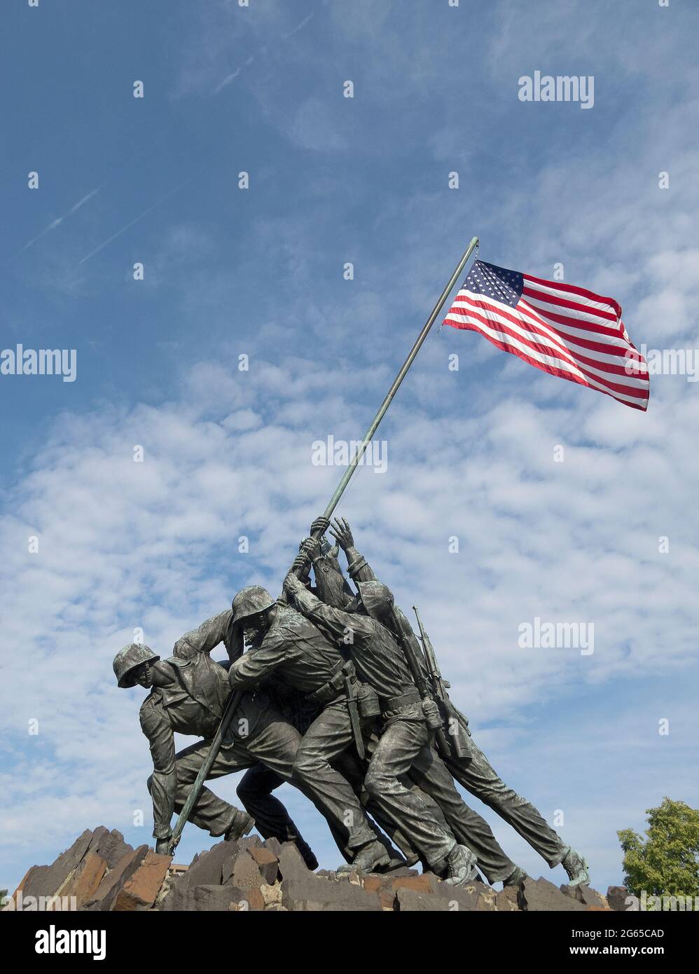 The American flag flutters above the Iwo Jima Memorial. Stock Photo
