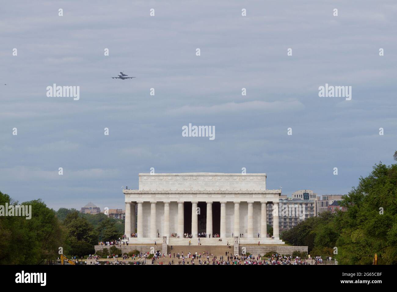The space shuttle Discovery flies over the Lincoln Memorial during its final flight. Stock Photo