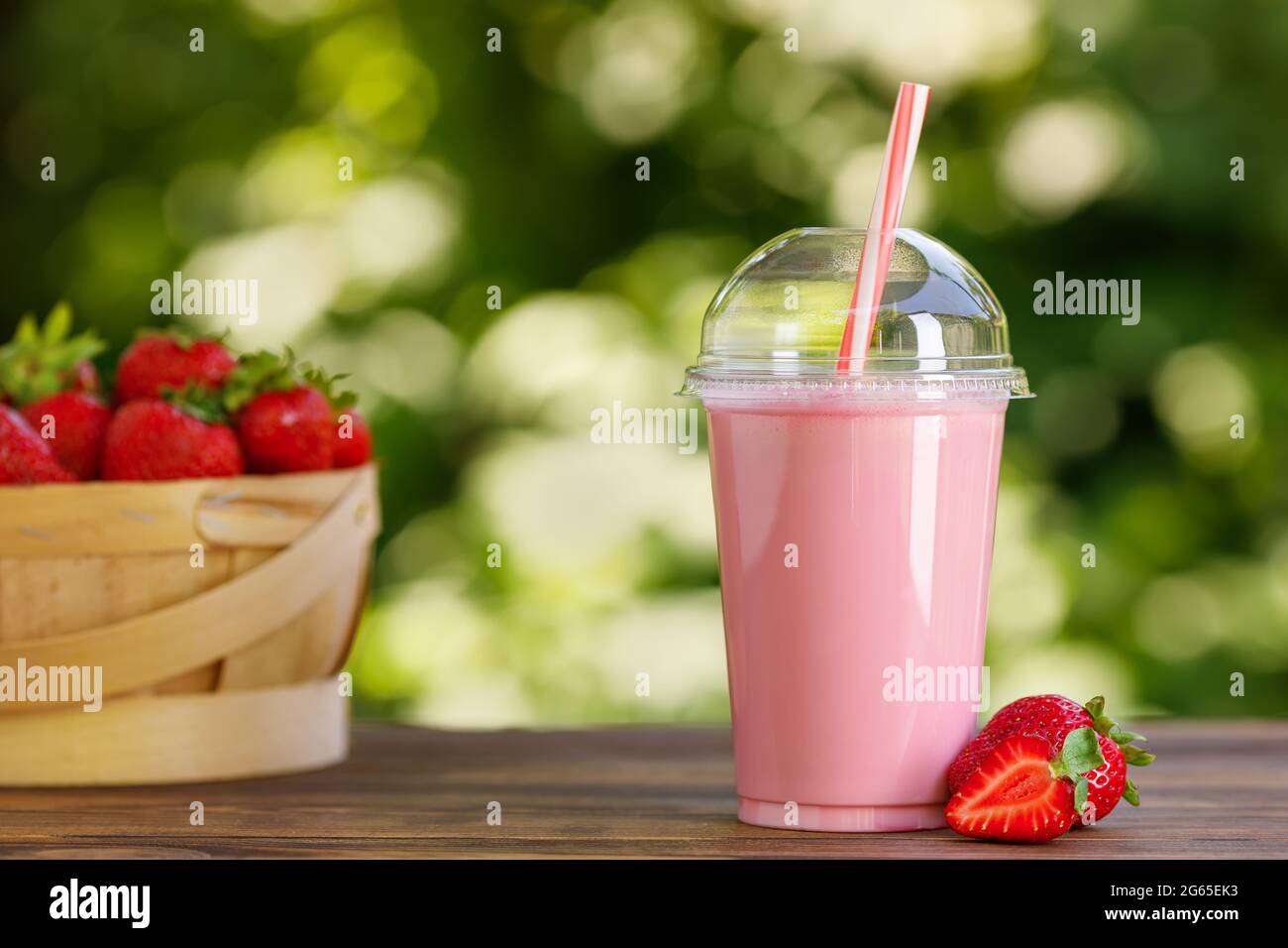 https://c8.alamy.com/comp/2G65EK3/strawberry-smoothie-in-disposable-plastic-glass-on-wooden-table-2G65EK3.jpg