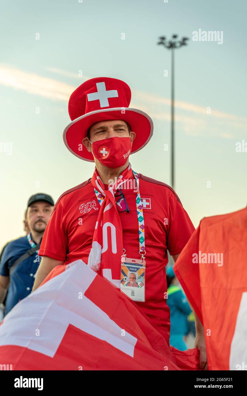 Swiss football fan in national outfit, red cap and red face mask, after UEFA EURO 2020 quarterfinal game Switzerland-Spain, St Petersburg, Russia Stock Photo