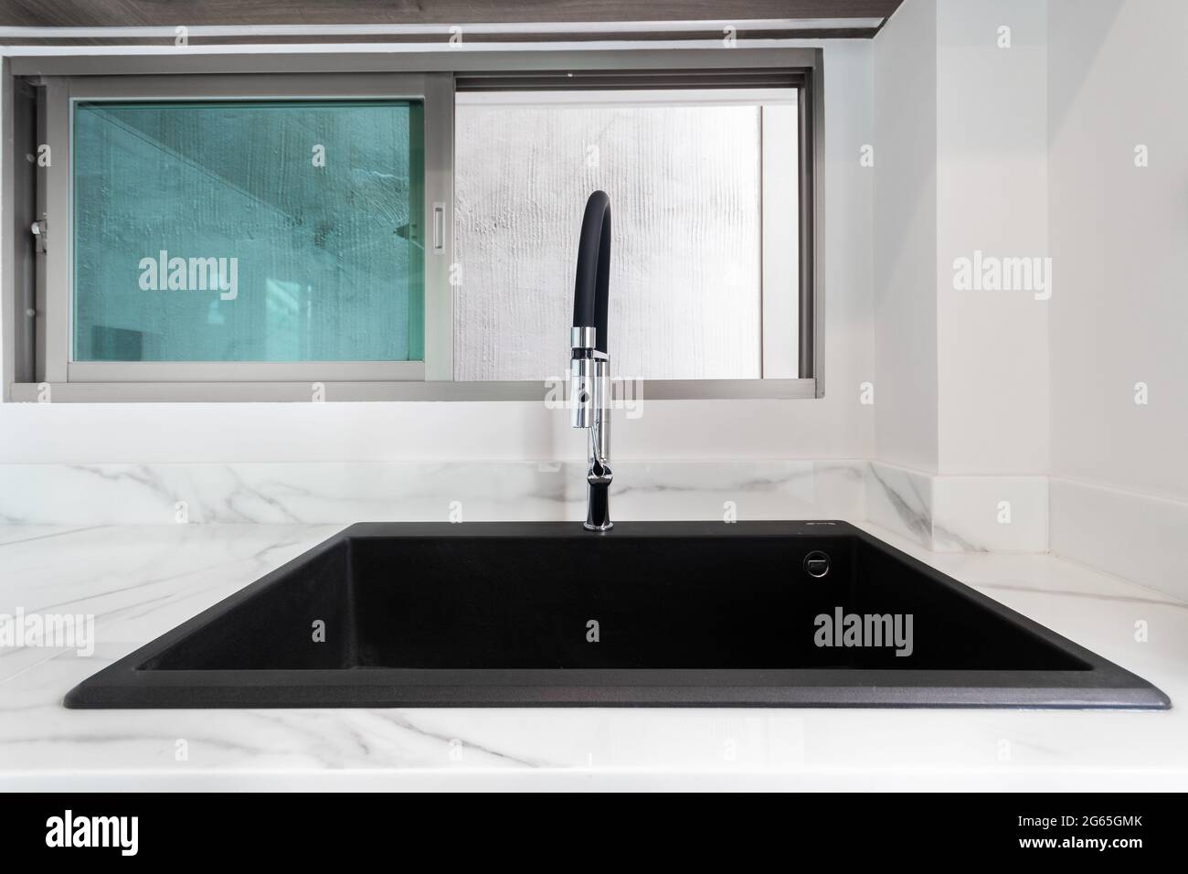 Luxurious black sink on a marble kitchen countertop Stock Photo Alamy