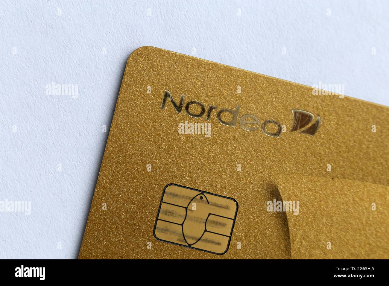 MasterCard Gold credit / debit card with contactless payment option in a closeup. Perfect card for luxury living. April 2020, Espoo, Finland. Stock Photo