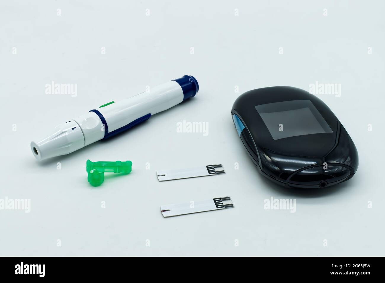 Electronic lancet pen and test strip isolated on white background. Diagnosis of