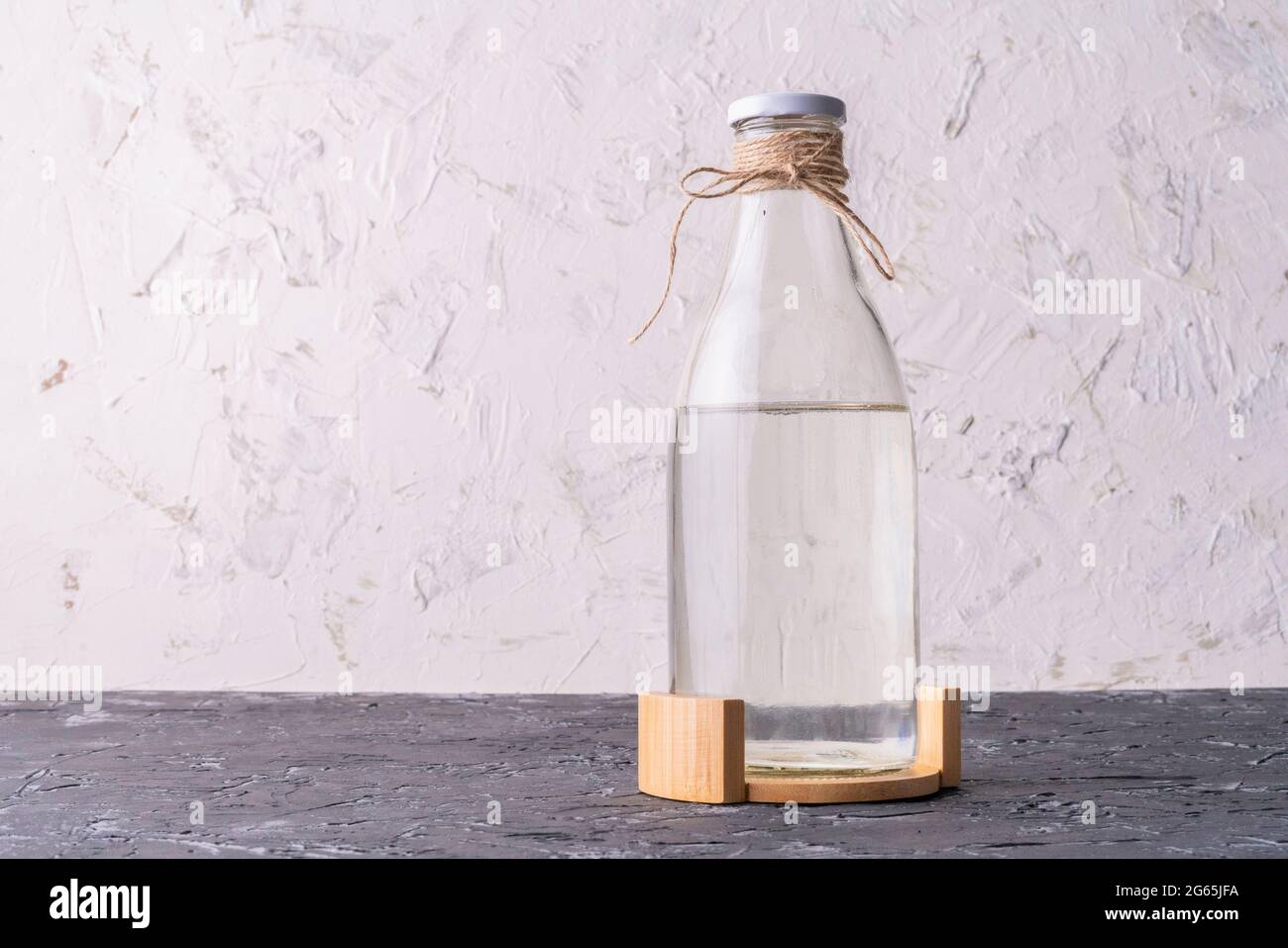 glass bottle with absolutely clean distilled water isolated on grunge  surface Stock Photo - Alamy