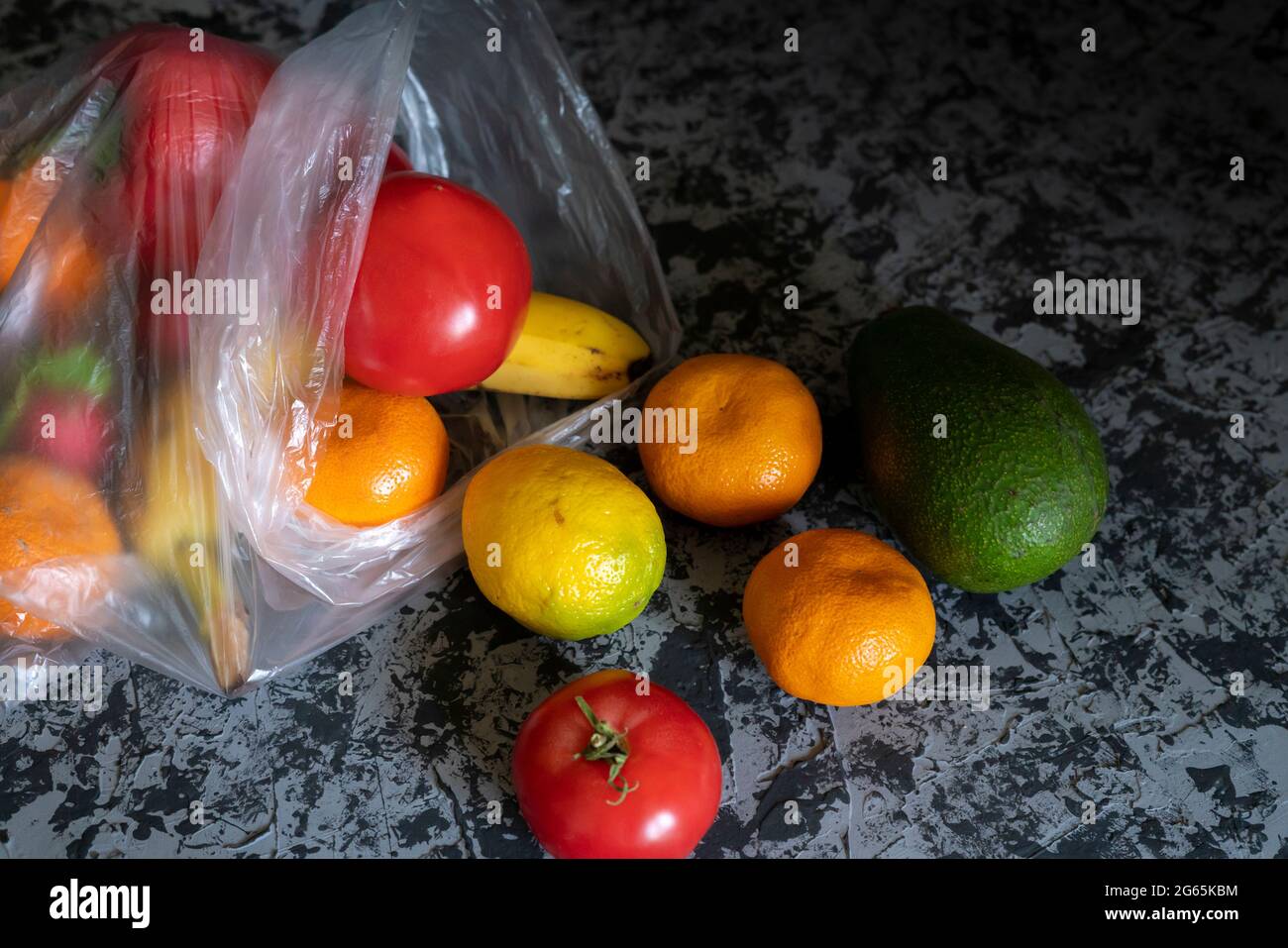 different fruits and vegetables in a plastic bag, vegetarian and vegan food concept Stock Photo