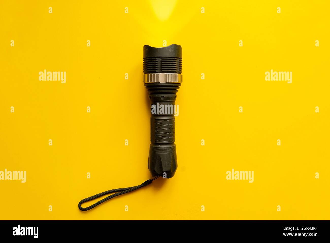 steel torch isolated on yellow surface, producing light beams or rays