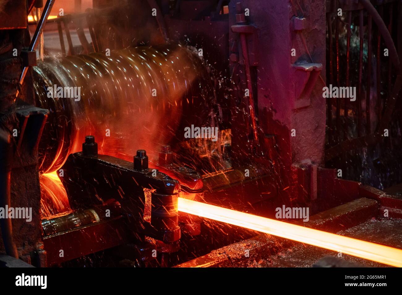 The rolling mill in operation. Manufacturing of hot rolled steel Stock Photo