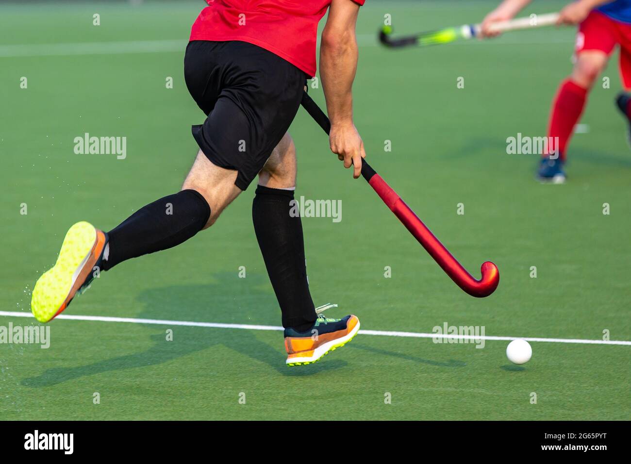 Field hockey player on artificial grass play field. Stock Photo