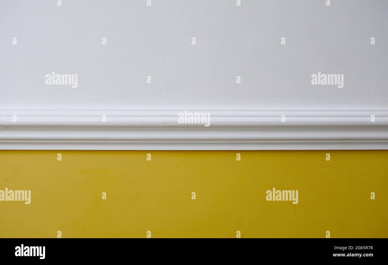 Interior image of white dado rail with yellow below and white above Stock Photo