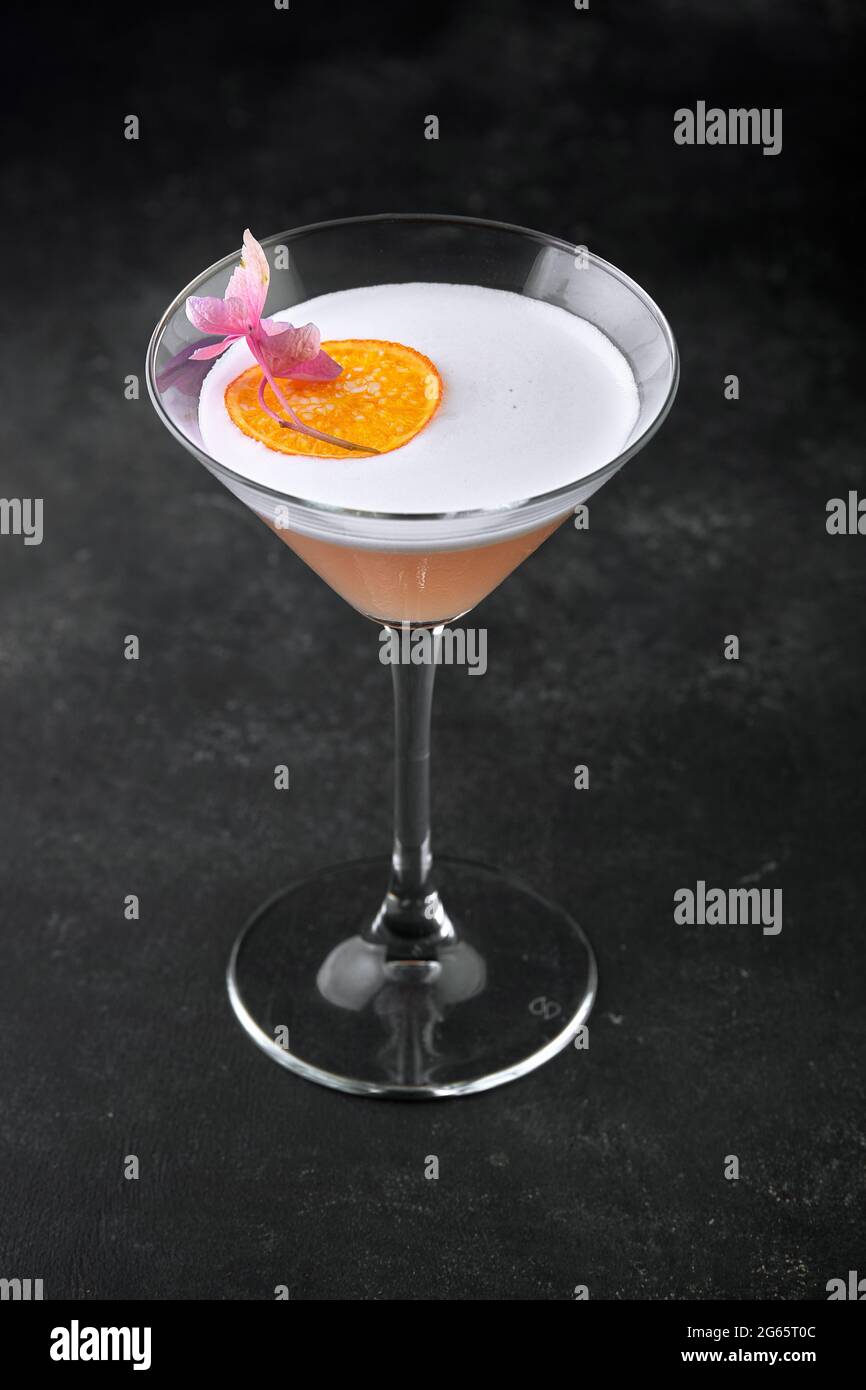 Whiskey sour cocktail in a glass on a black background Stock Photo