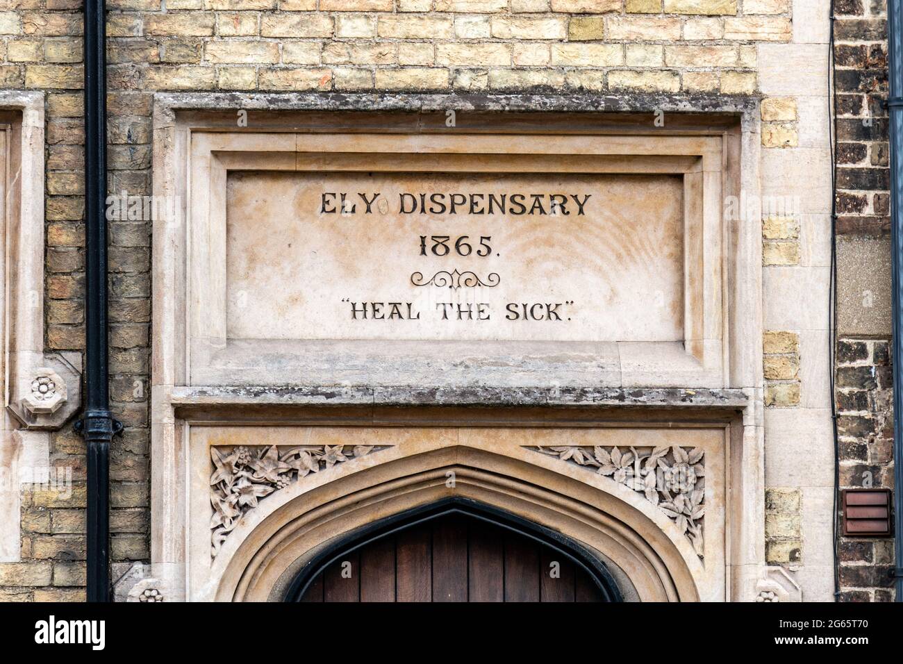 The Ely Dispensary, built in 1865, is now a community space.  Above the door is a plaque engraved with 'Heal the Sick'. Stock Photo