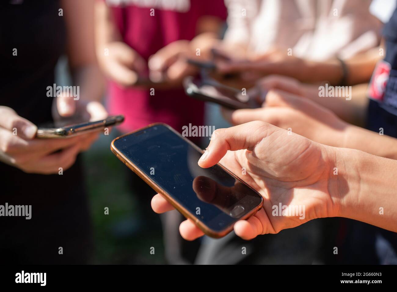 Close up of group of teenages using mobile phones. Social networking concept Stock Photo
