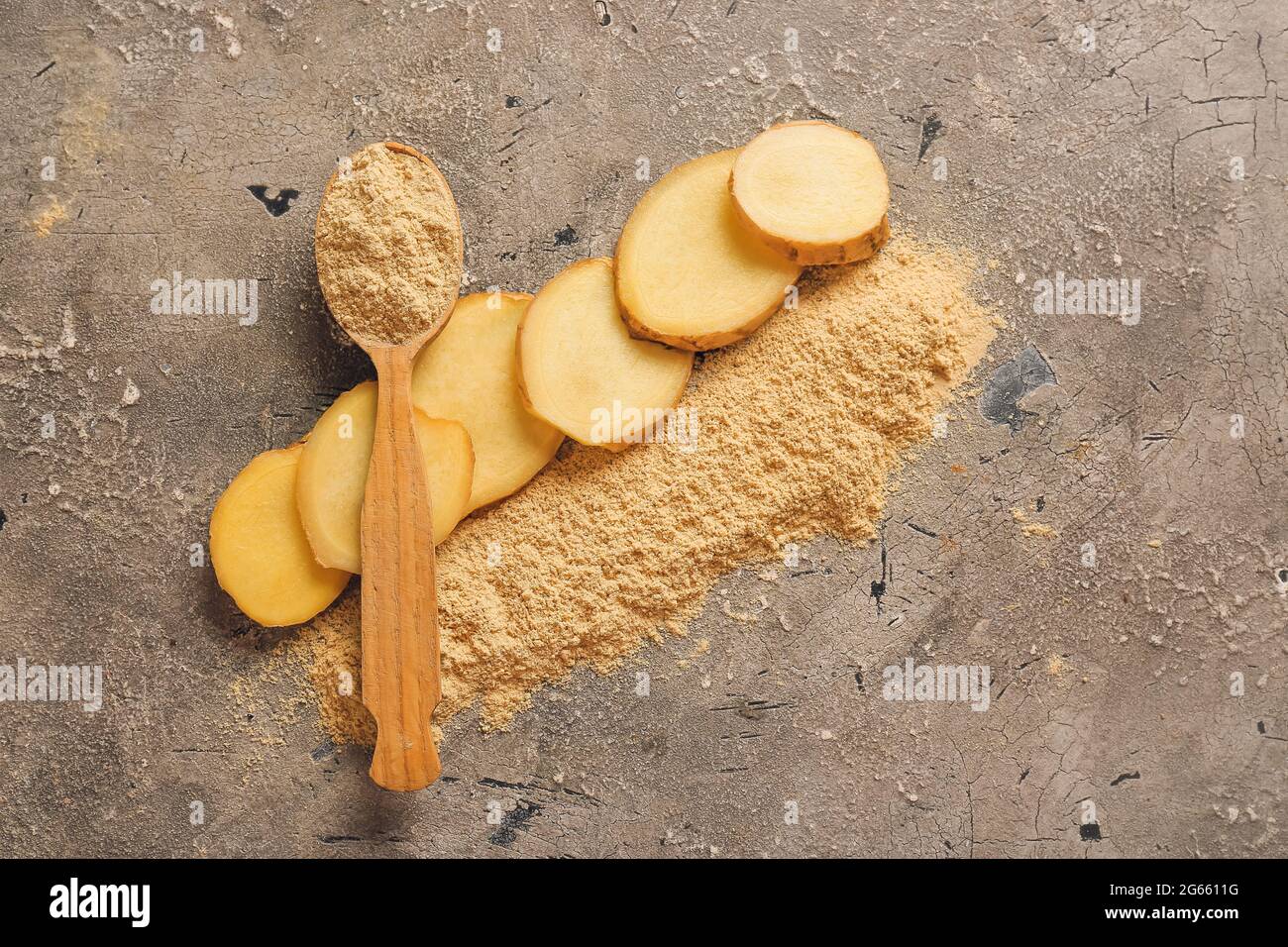 Spoon with ginger powder on grunge background Stock Photo