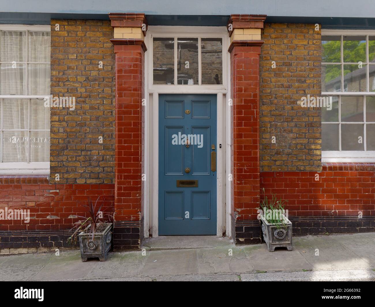 London, Greater London, England - June 26 2021: Blue front door with plant pots outside in Hampstead. Stock Photo