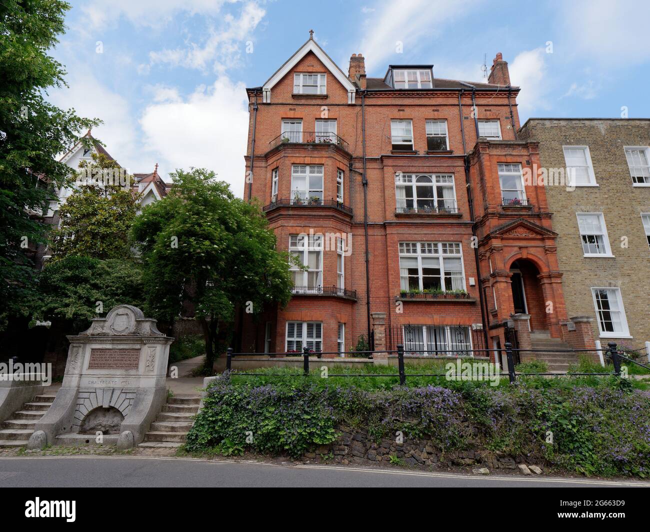 London, Greater London, England - June 26 2021:  The chalybeate springs of Hampstead, known as Hampstead Well next to a large residential property. Stock Photo