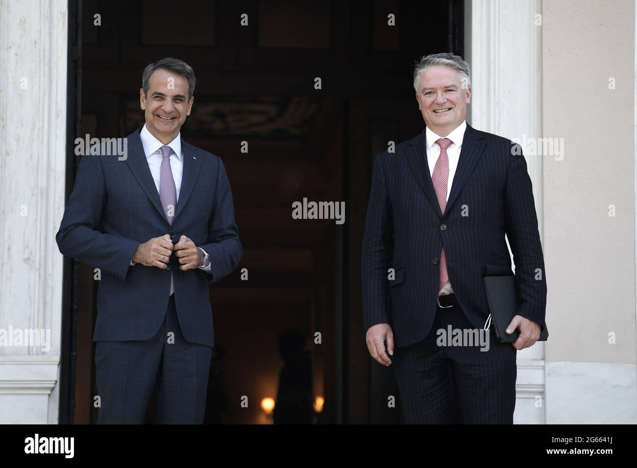 (210703) -- ATHENS, July 3, 2021 (Xinhua) -- Greek Prime Minister Kyriakos Mitsotakis (L) welcomes Organization for Economic Co-operation and Development (OECD) Secretary-General Mathias Cormann in Athens, Greece, July 2, 2021. International cooperation is more important than ever to deal with the challenges of our time, Mathias Cormann said on Friday during a visit to Athens. (Photo by Nick Paleologos/Xinhua) Stock Photo
