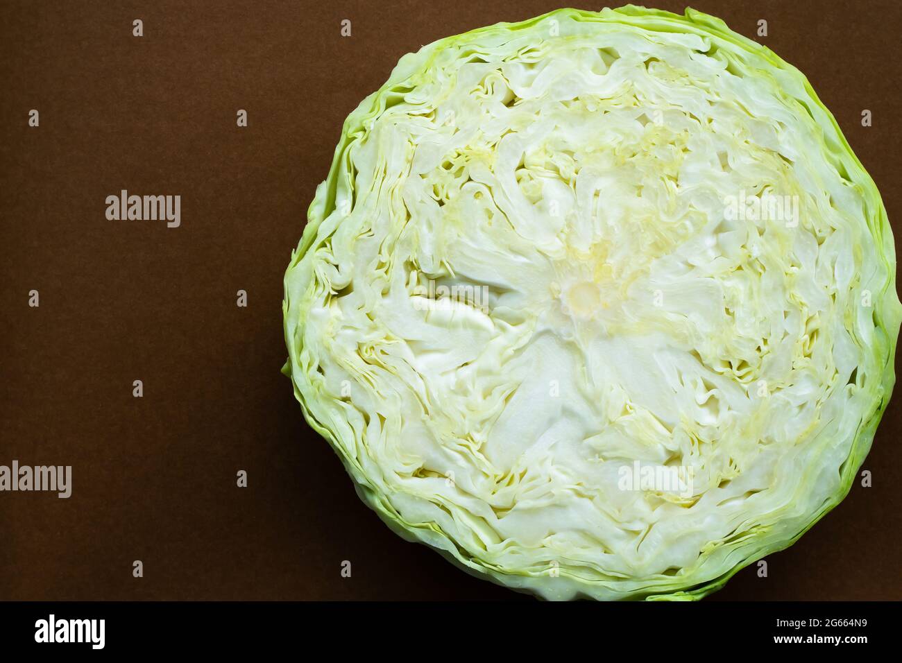 High angle view of half full cabbage on brown background, copy space ...