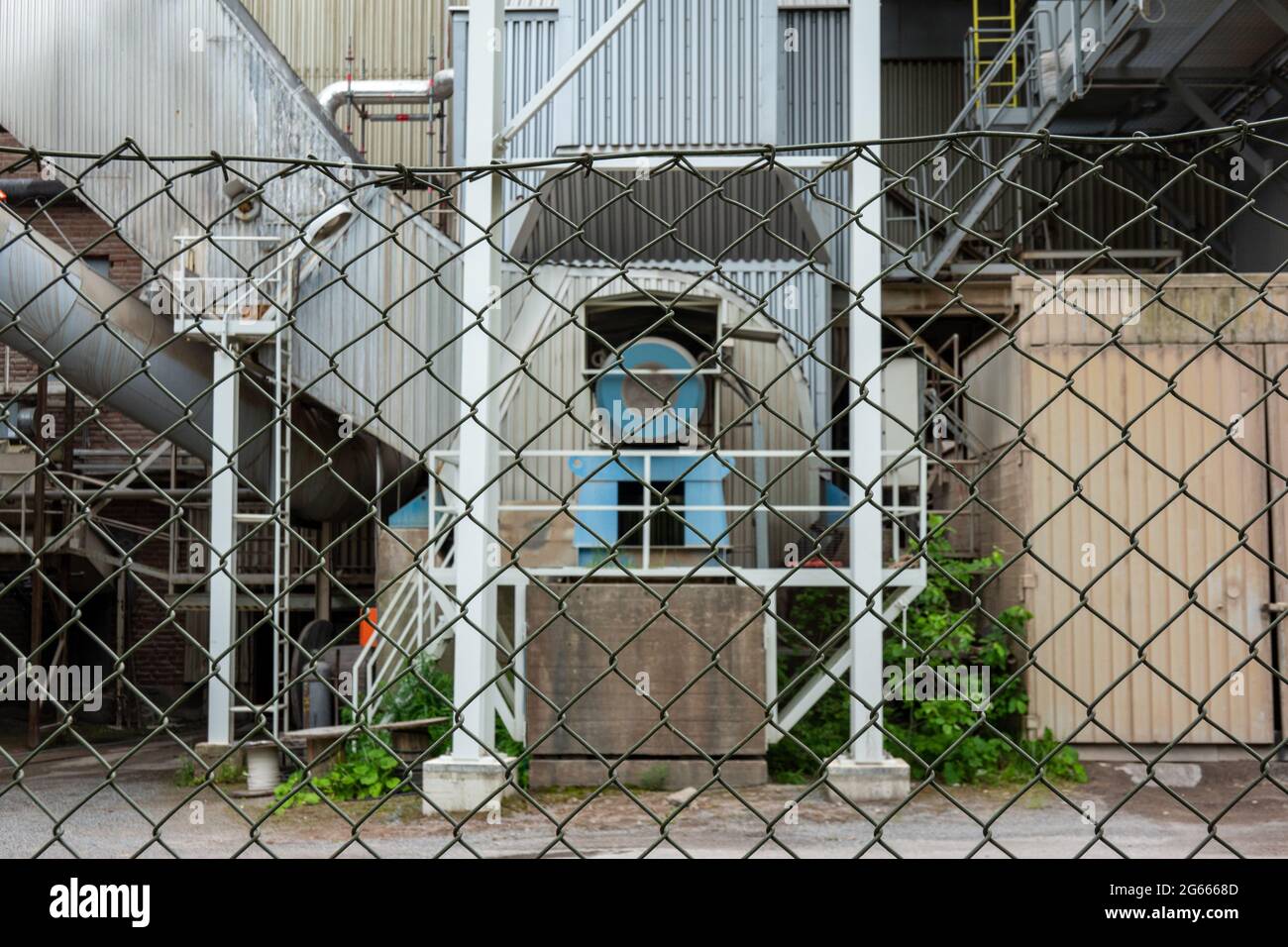 Industrial property behind chain link fence Stock Photo