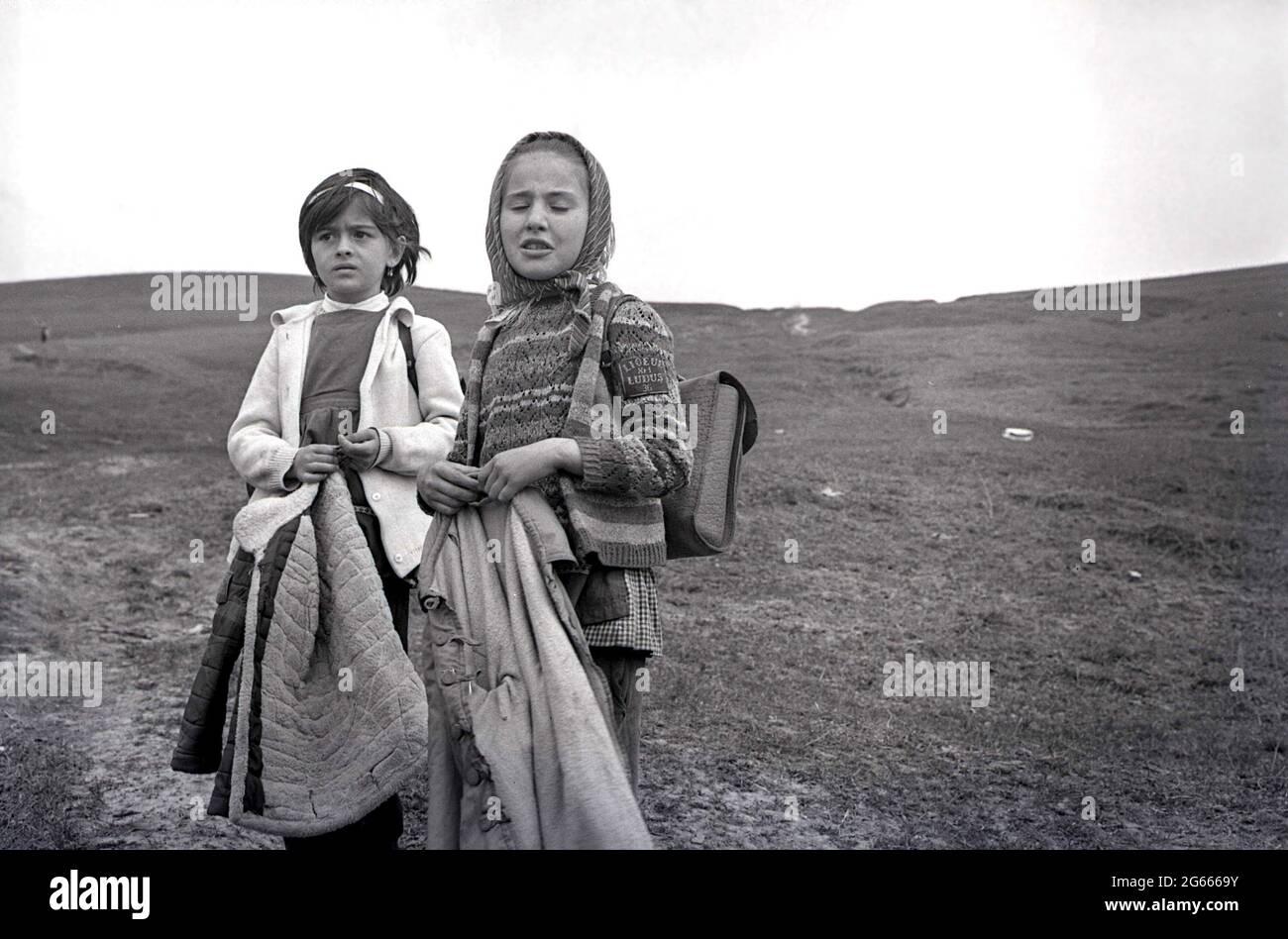 Socialist Republic of Romania, approx 1973. Young girls walking to school a long distance in the countryside. Stock Photo