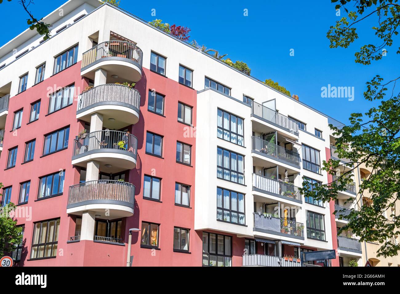 Apartment building with some tree branches seen in Berlin Stock Photo