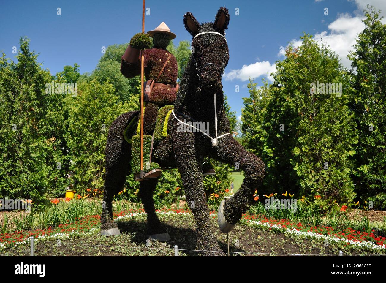 A Royal Canadian Mounted Police Officer (RCMP officer) on his mount, a famous Canadian icon, in topiary, Ontario, Canada. Like IRL. Lifesize,. Stock Photo