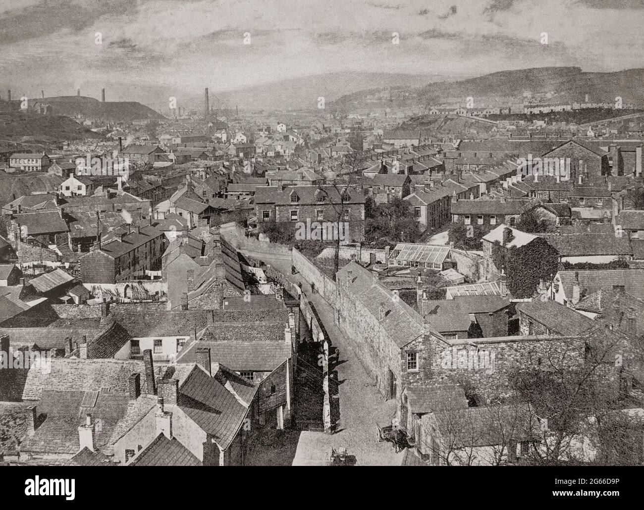 A late 19th century aerial view of Merthyr Tydfil in Glamorganshire, South Wales. Close to reserves of iron ore, coal, limestone, timber and water, it was an ideal site for ironworks and in the wake of the Industrial Revolution the demand for iron led to the rapid expansion of Merthyr's iron operations housing four of the greatest ironworks in the world: Dowlais Ironworks, Plymouth Ironworks, Cyfarthfa Ironworks and Penydarren. Stock Photo