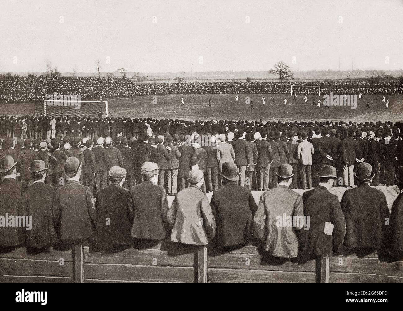 A late 19th century view of spectators (all wearing headgear) at a football match at the Fallowfield Ground in Manchester, England between Everton and Wolverhampton Wanderers. Stock Photo