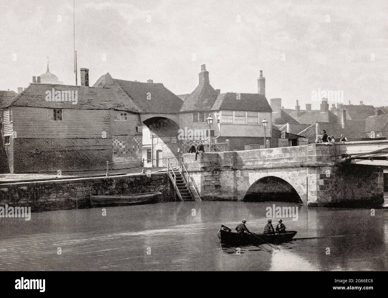A late 19th century view of the River Stour and the 14th century Barbican gateway built in the late 14th century and later occupied by the toll collector for the Sandwich Toll Bridge, in Sandwich, Kent, England. Sandwich was one of the Cinque Ports and also gave its name to the food by way of John Montagu, 4th Earl of Sandwich, and the word sandwich is now found in several languages. Stock Photo