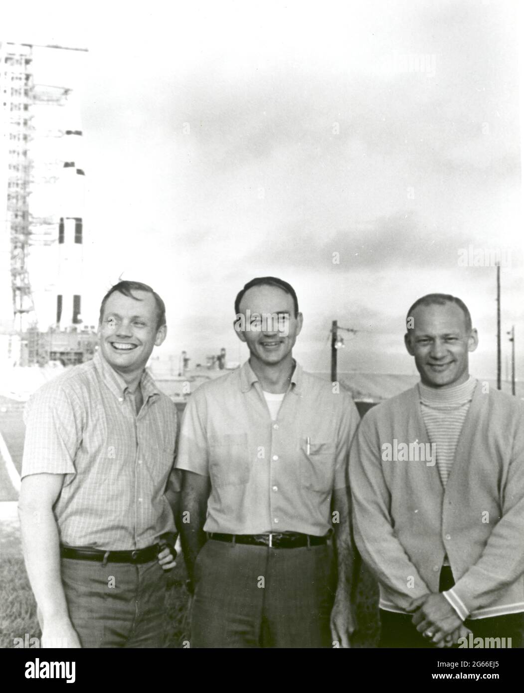 NASA's Apollo 11 flight crew, Neil A. Armstrong, commander; Michael Collins, command module pilot; and Buzz Aldrin, lunar module pilot stand near the Apollo/Saturn V space vehicle that would eventually carry them into space on July 16,1969. Stock Photo