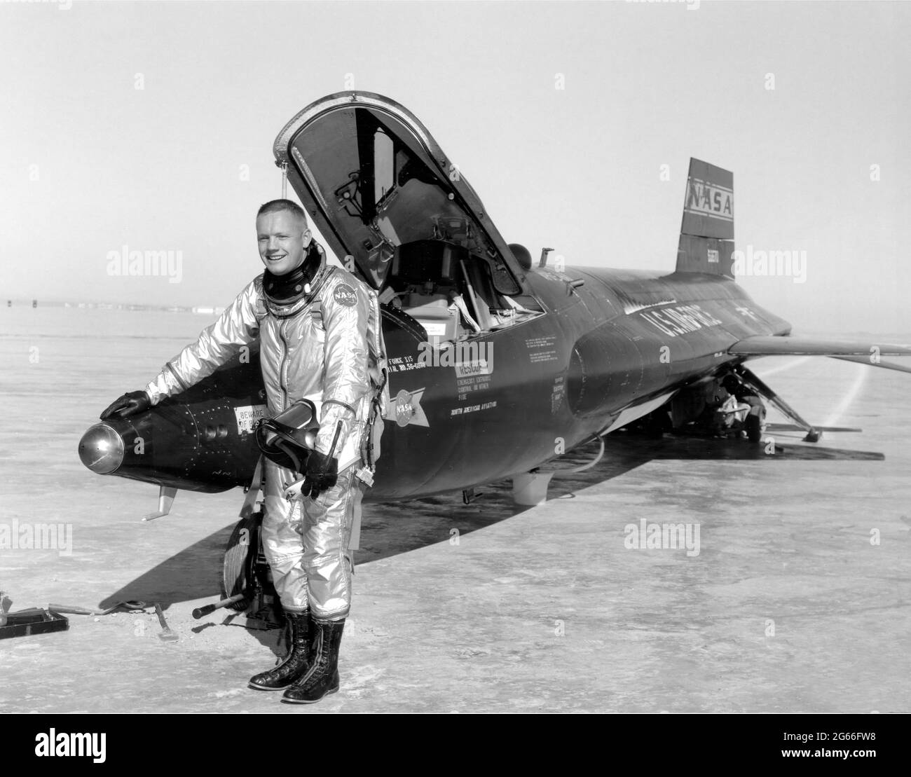 Dryden pilot Neil Armstrong is seen here next to the X-15 ship #1 (56-6670) after a research flight. The X-15 was a rocket-powered aircraft 50 feet long with a wingspan of 22 feet. It was a missile-shaped vehicle with an unusual wedge-shaped vertical tail, thin stubby wings, and unique side fairings that extended along the side of the fuselage. The X-15 was flown over a period of nearly 10 years, from June 1959 to October 1968. It set the world's unofficial speed and altitude records. Information gained from the highly successful X-15 program. Stock Photo