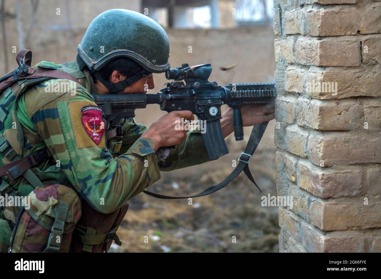 SUJANI, AFGHANISTAN - 20 Jan 2018 - An Afghan National Army 10th Special Operations Kandak Commando returns fire during offensive operations against t Stock Photo