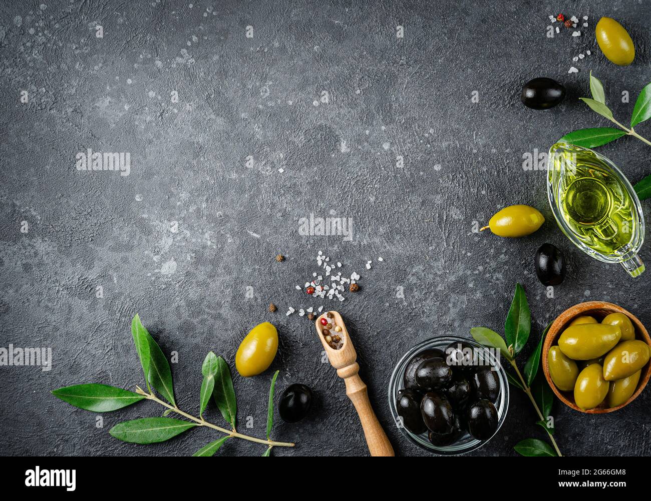 Food border background of green and black olives with branches. Top view, copy space. Stock Photo