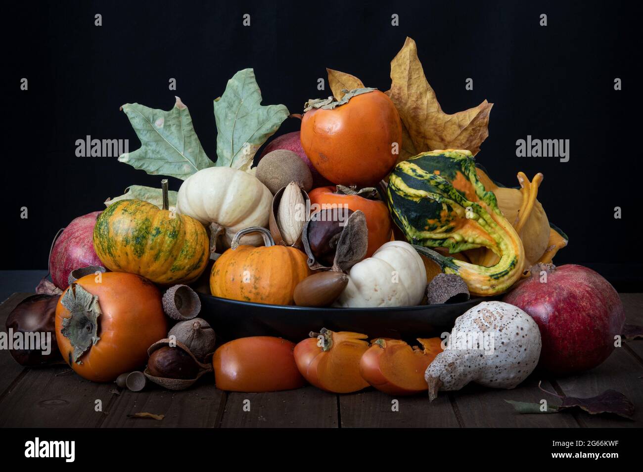 Top of basket with assorted fruit and vegetables against white background, side view, and decorated with sunflowers, summer harvest concept, Californi Stock Photo