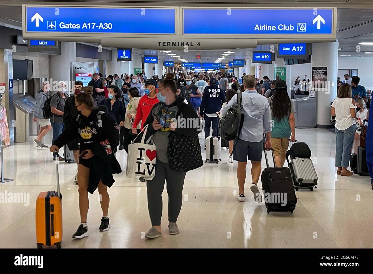 People walk through Terminal 4 of the Sky Harbor International Airport